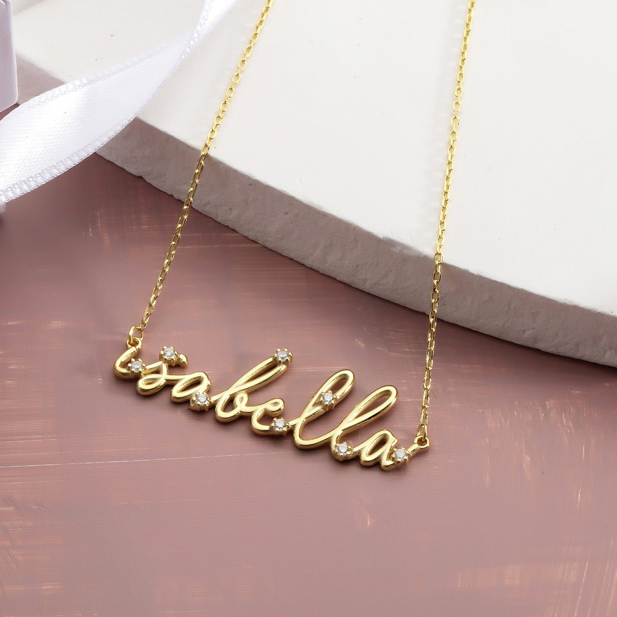 Small script name necklace gift close-up with ribbon