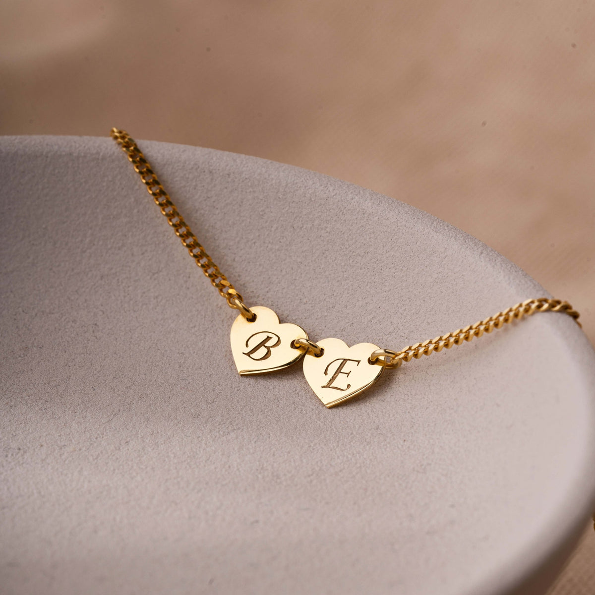 Initial heart necklace in 14K gold vermeil with two engraved heart charms, close-up