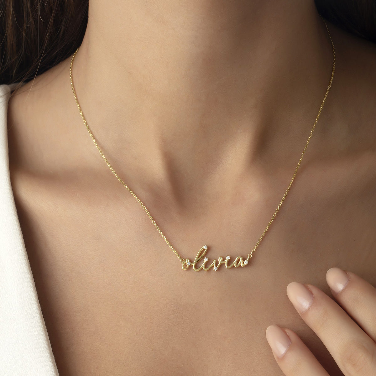 Simulated diamond script name necklace worn by a woman in 14K gold vermeil